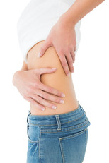 woman in blue denim jeans and white shirt experiencing rib pain