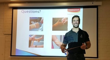 Chiropractor Joshua Basham addressing questions at a sports medicine presentation